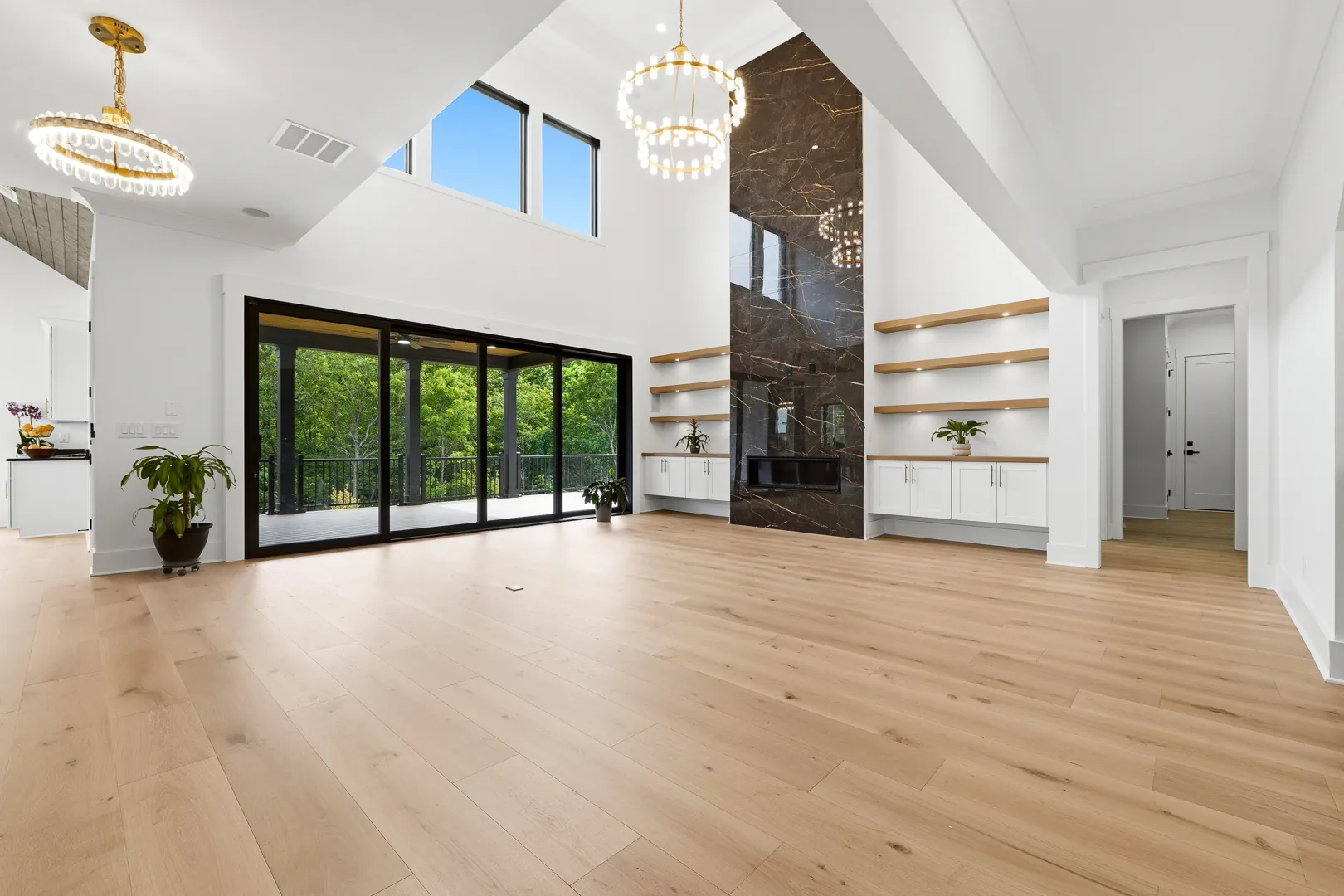 Great room with a black marble fireplace and a wall of glass at 3610 Sky Lane