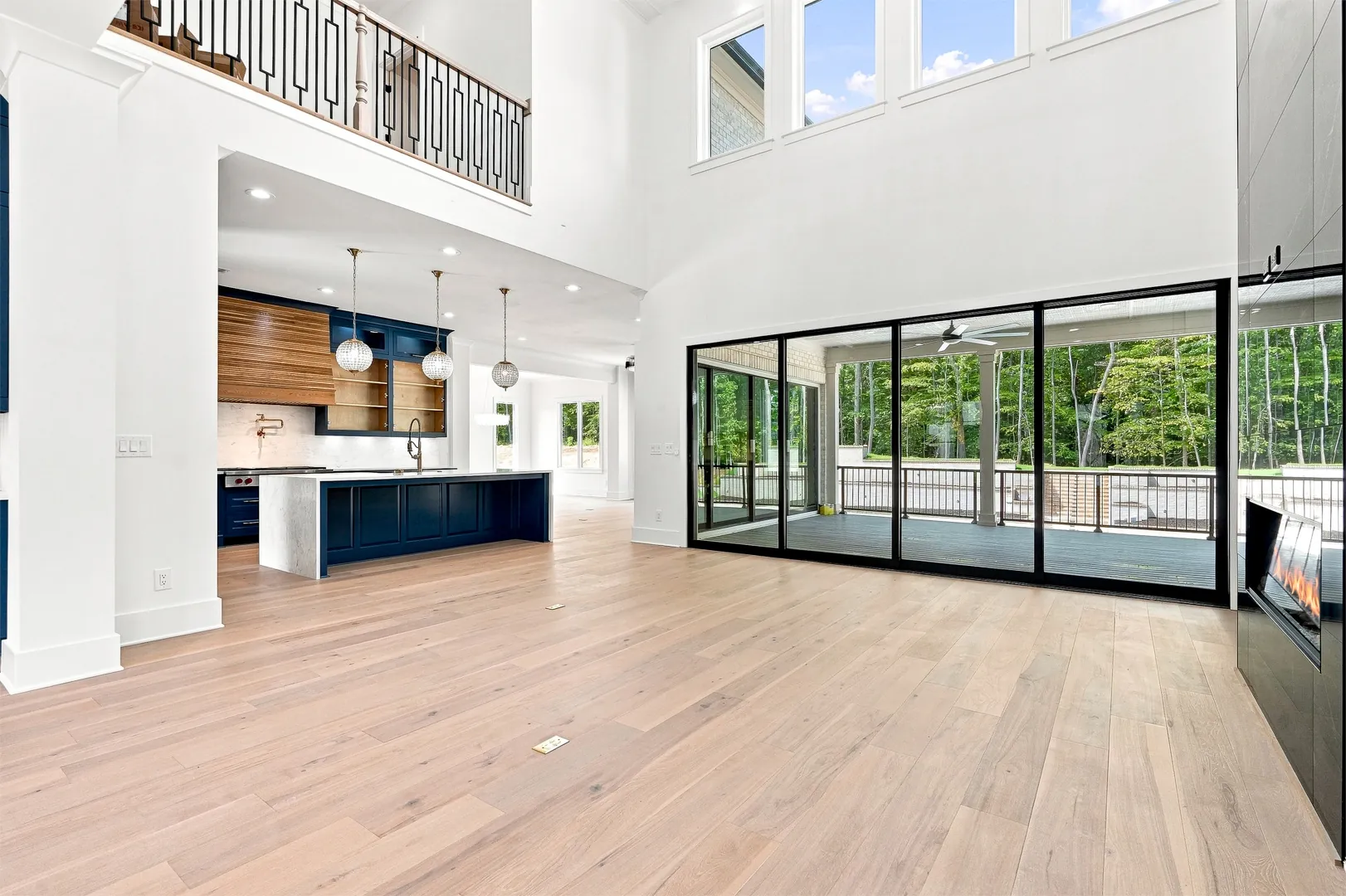 Two-story family room open to the kitchen and terrace