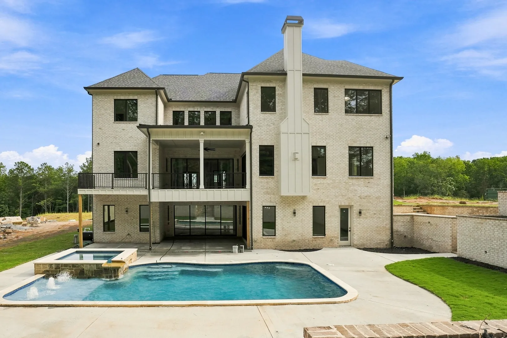 Brick home at 3615 Sky Lane with a pool, raised spa and covered terraces